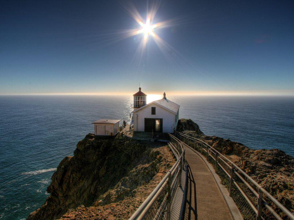 1024x768 Download wallpaper 1024x768 small house, sun, beacon, road, ocean, mountains standard 4:3 HD background