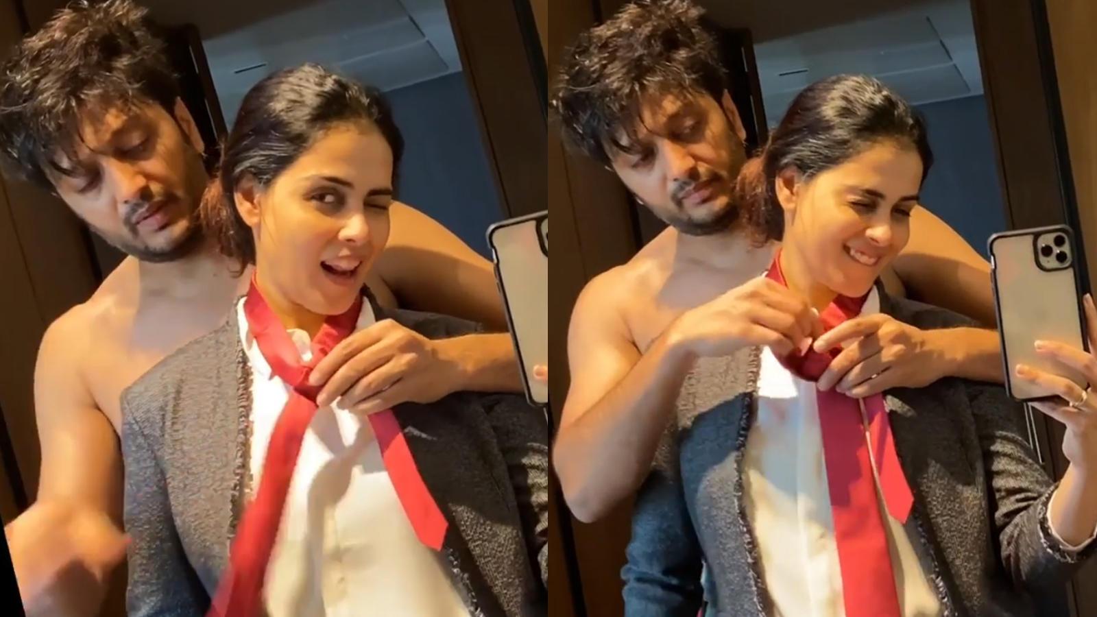 1600x900 Cuteness alert! Genelia D'Souza's expressions are unmissable as hubby Riteish Deshmukh ties her necktie shirtless. Hindi Movie News of India