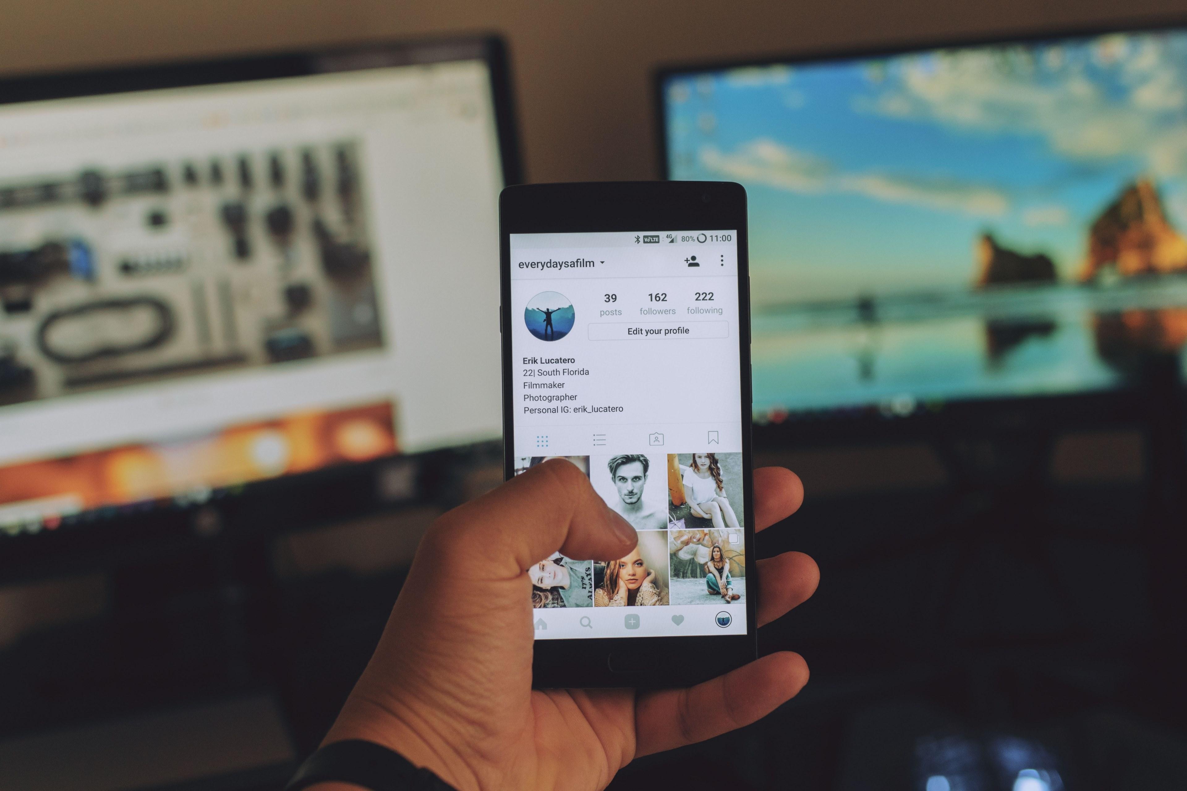 3840x2560 Wallpaper / a person holding a smartphone with an instagram profile on its screen, live to capture live to share 4k wallpaper free download