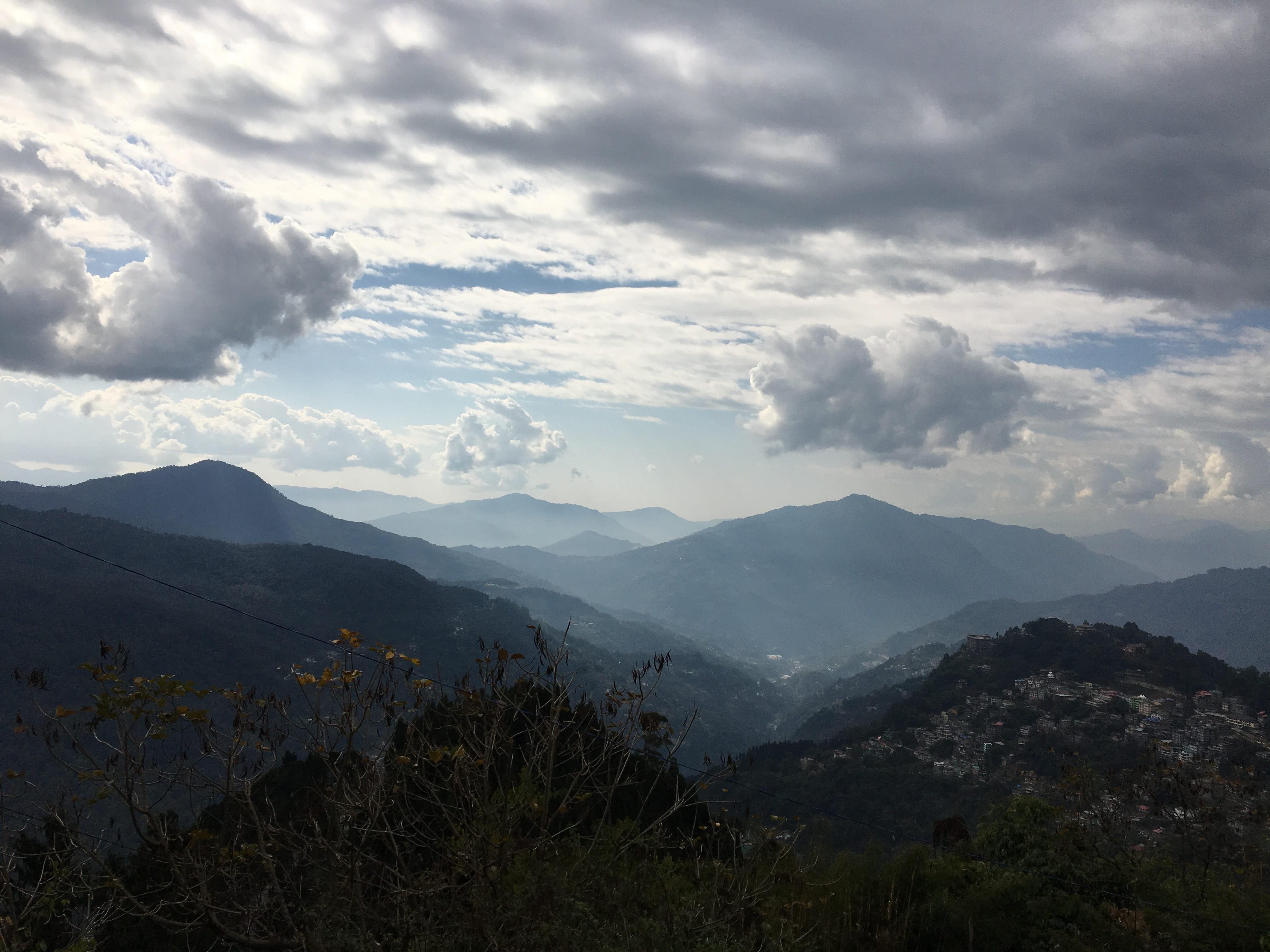4032x3024 Wallpaper / sunny, hill, environment, beauty in nature, mountain peak, gangtok, tranquility, vacation, range, remote, idyllic, blue, majestic, land, tourism, landscape free download
