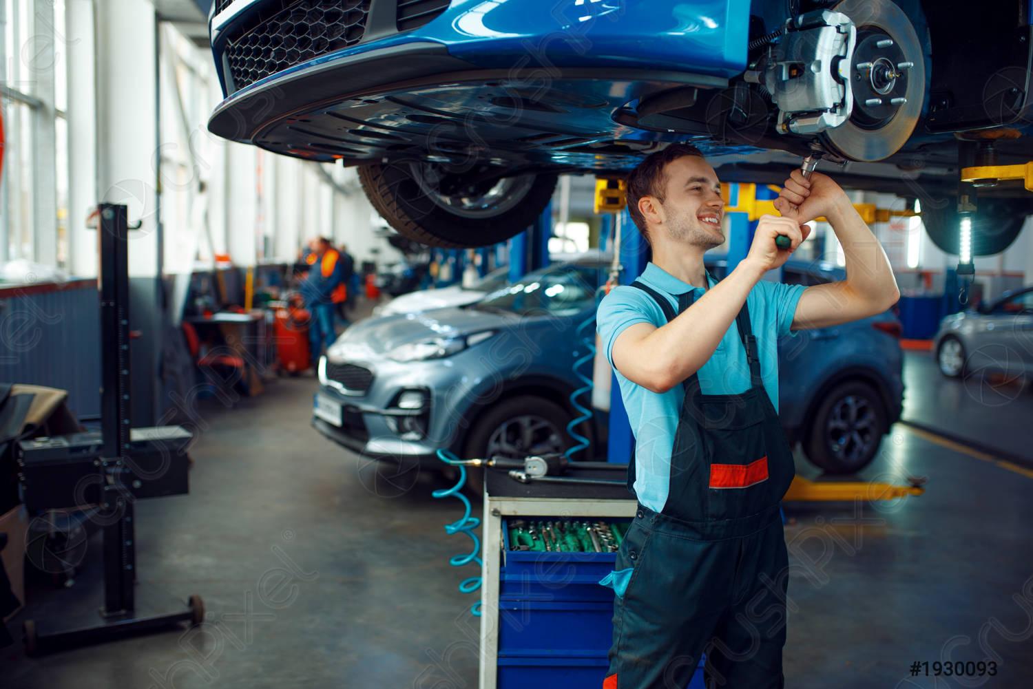 1500x1001 Worker repairing vehicle on lift, car