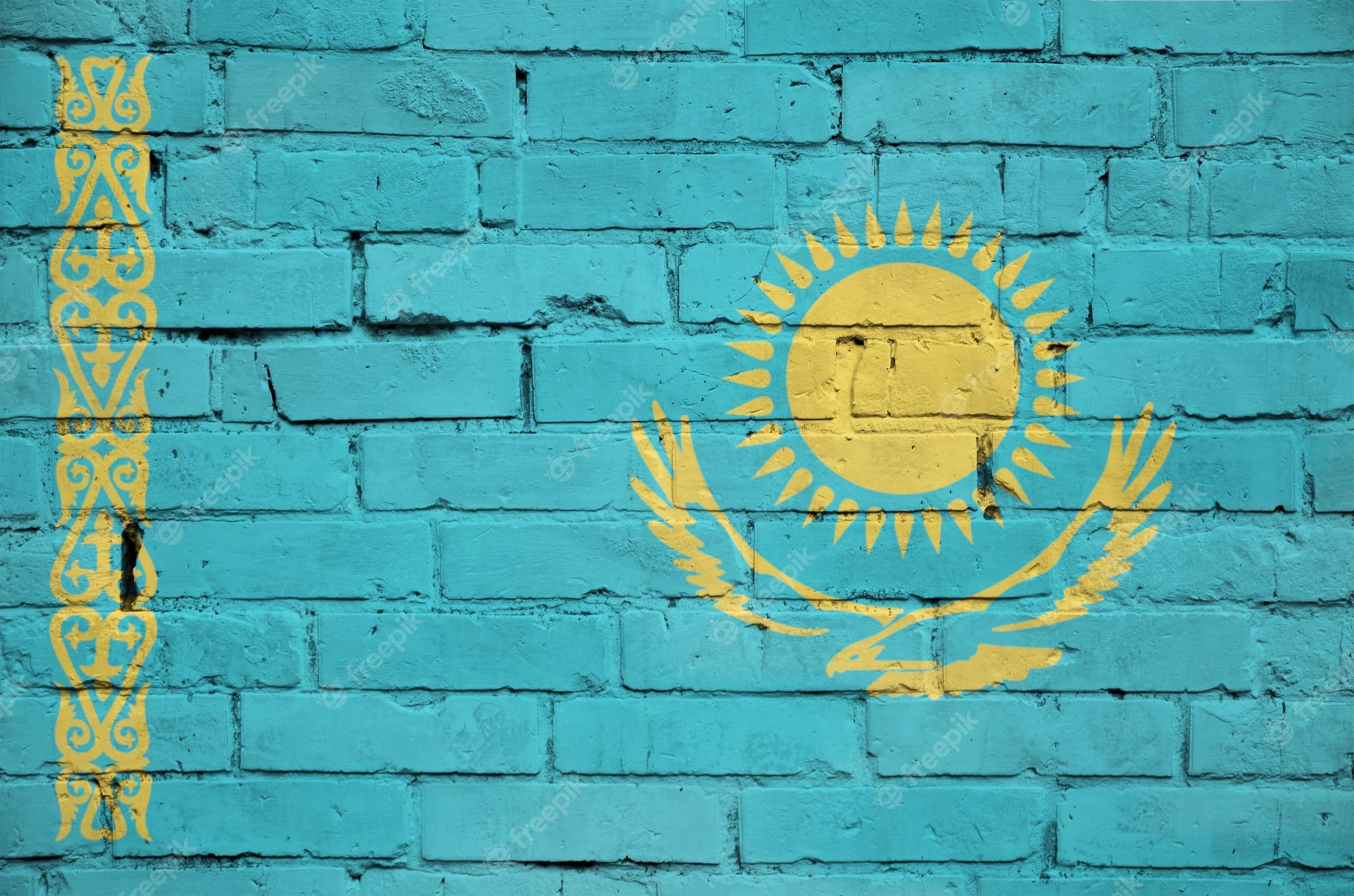 2000x1324 Premium Photo. Kazakhstan flag is painted onto an old brick wall