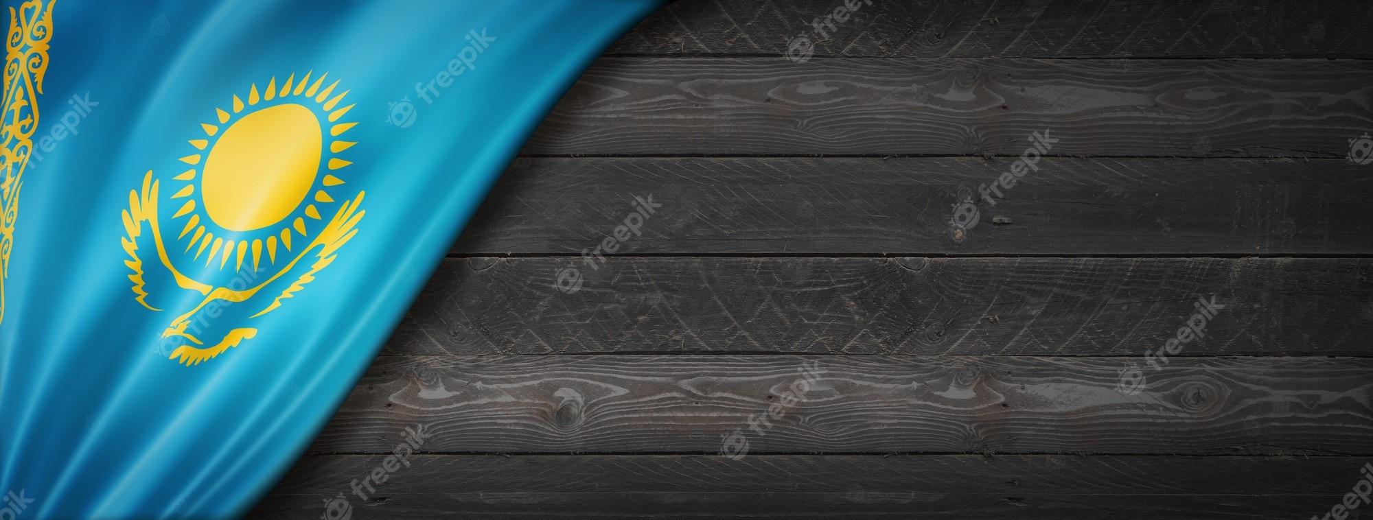 2000x758 Premium Photo. Kazakhstan flag on black wood wall
