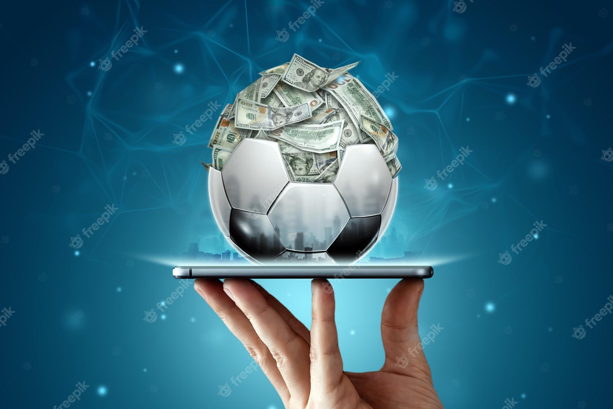 2000x1333 Premium Photo. Dollars are inside the soccer ball, the ball is filled with money in a smartphone. sports betting, soccer betting, gambling, bookmaker, big win