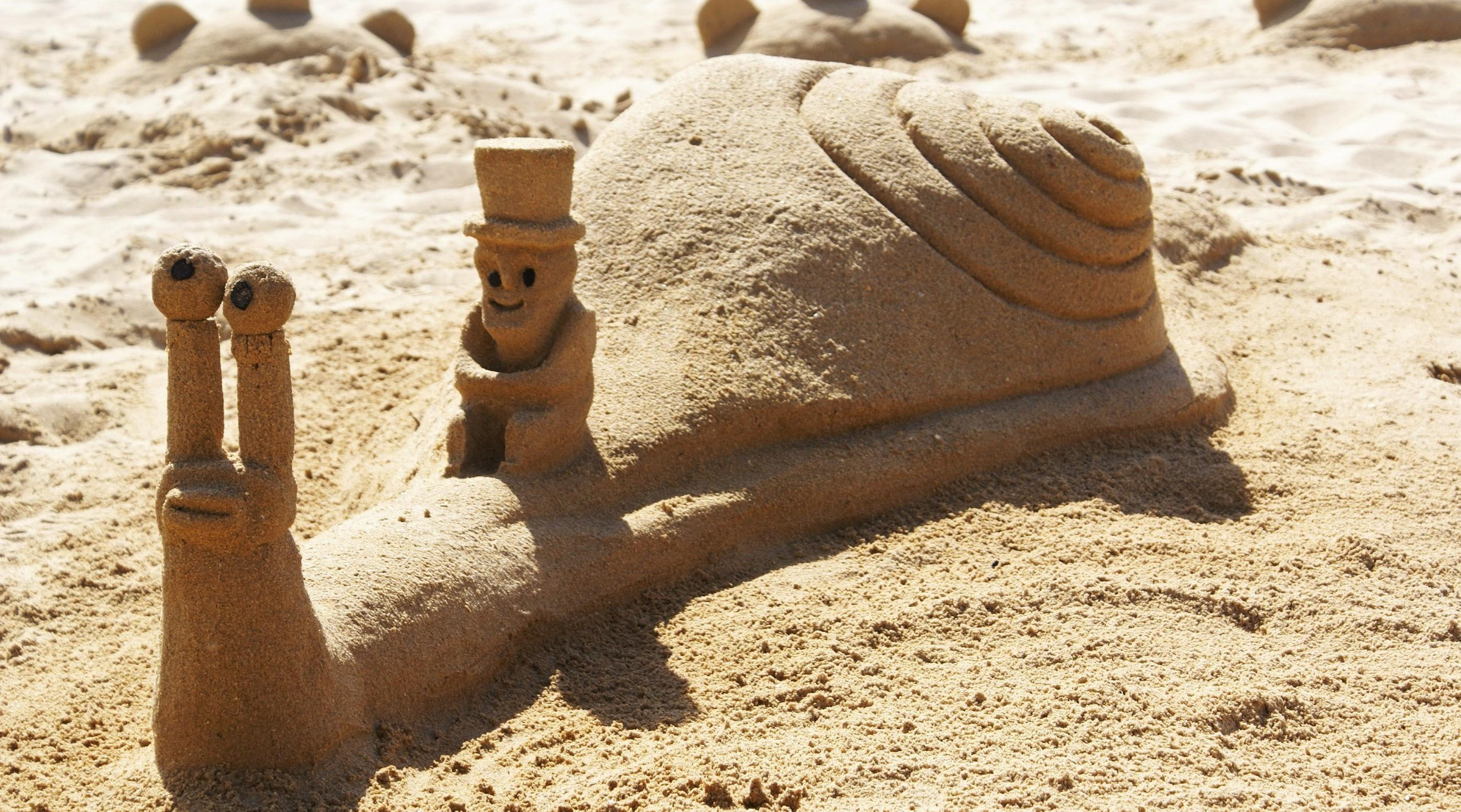 2797x1555 Wallpaper / sand castle, sand, beach, snail, 2K free download