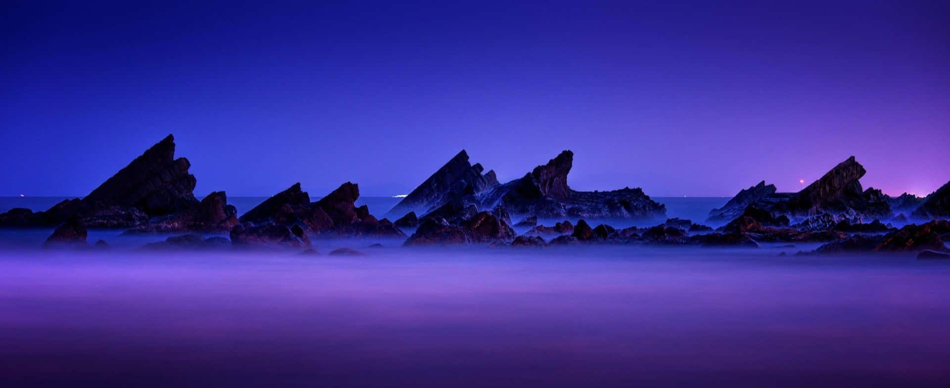 1920x785 Rocky Purple Coast Wallpaper