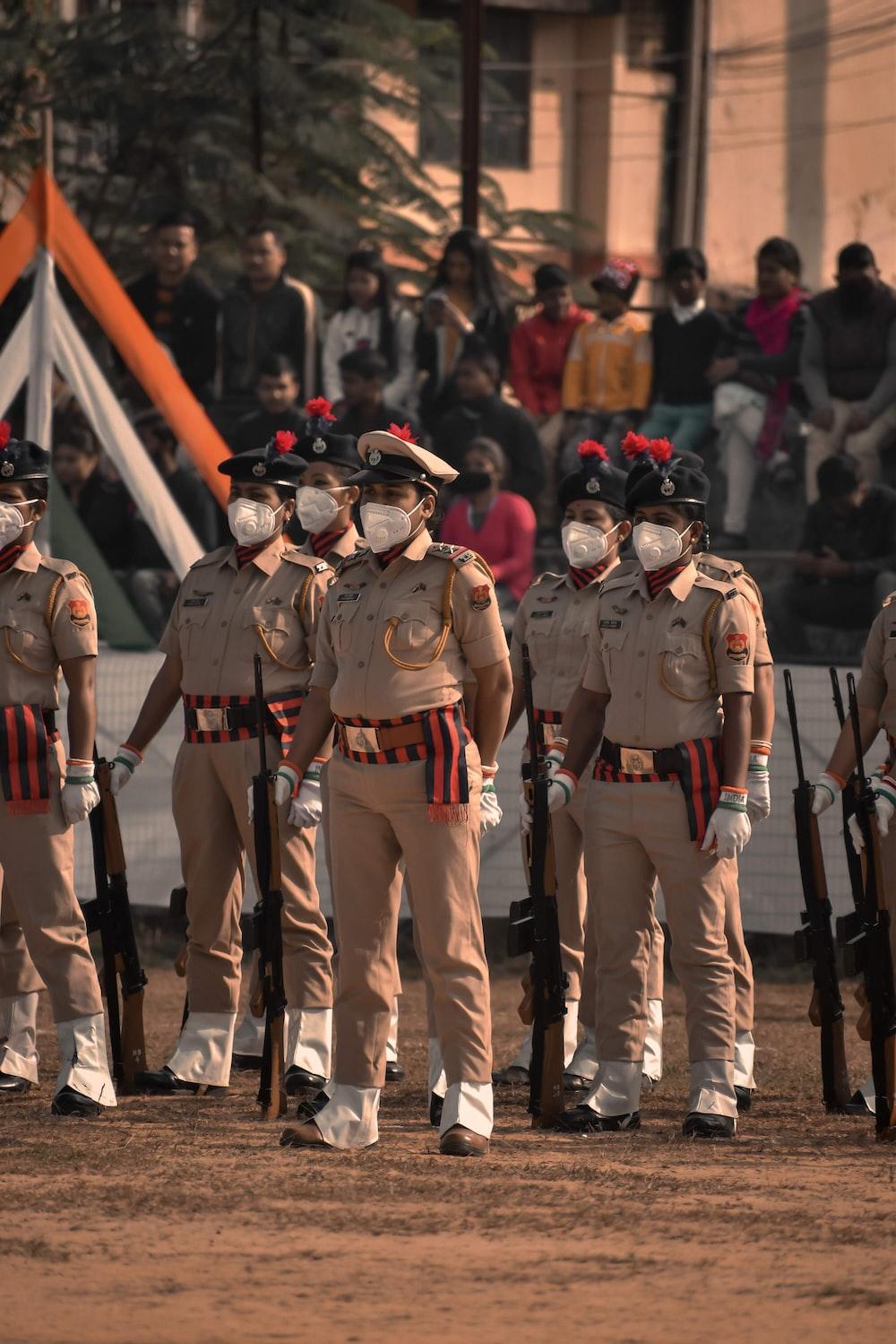1000x1499 Men in brown uniform standing during daytime photo