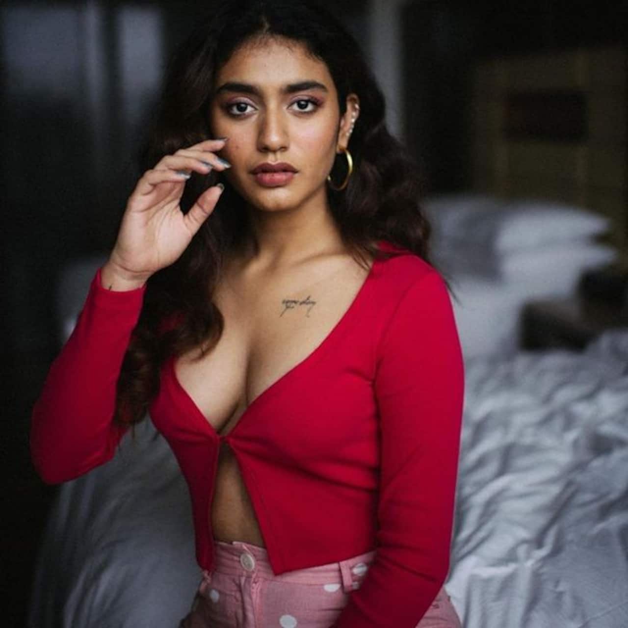 1280x1280 Wink Girl' Priya Prakash Varrier shares steamy bedroom picture wearing a red hot top with plunging neckline