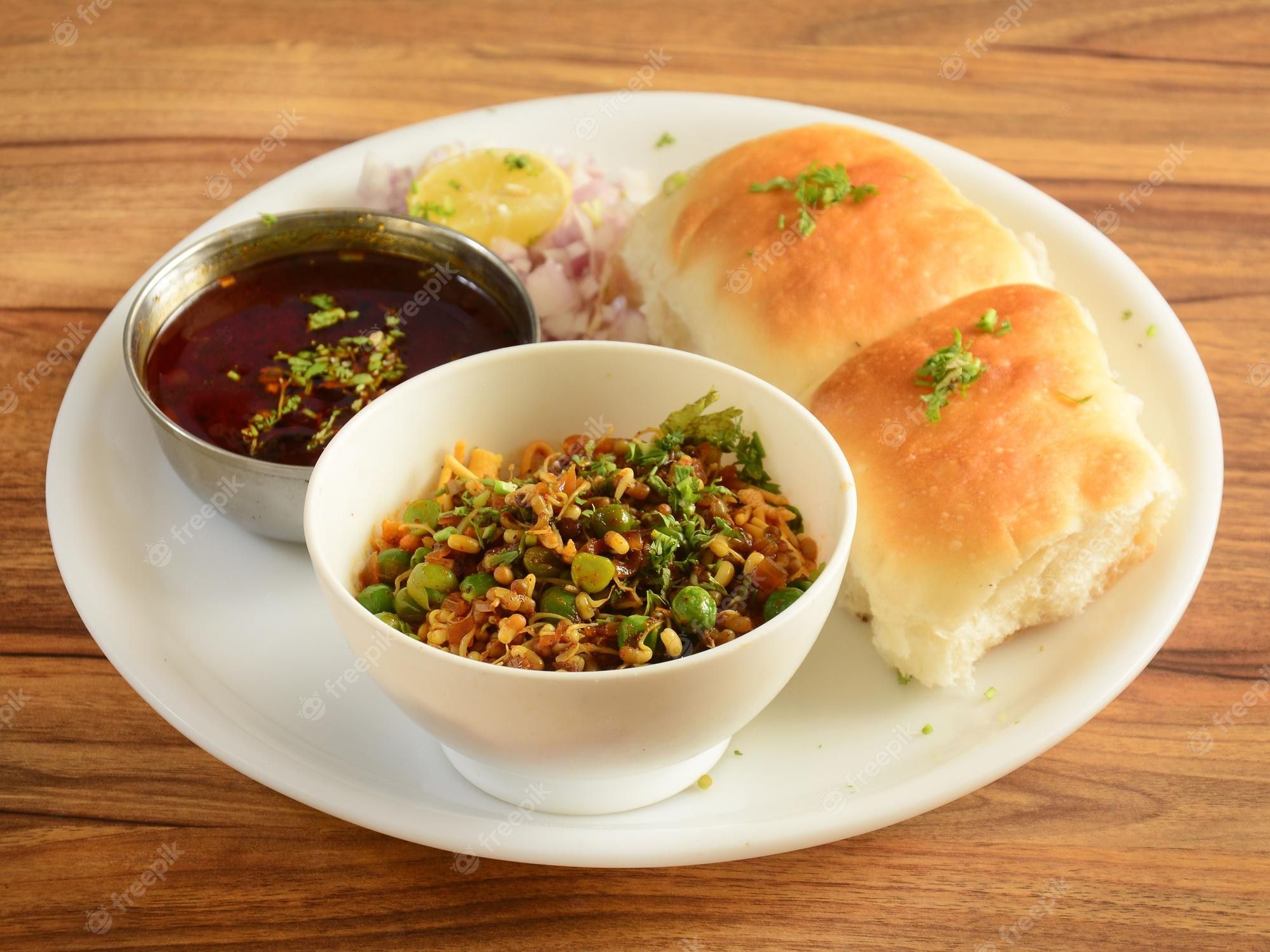2000x1500 Premium Photo. Misal pav is a special dish in maharashtra india the dish is eaten for breakfast or as a midday snack served over a rustic wooden background selective focus