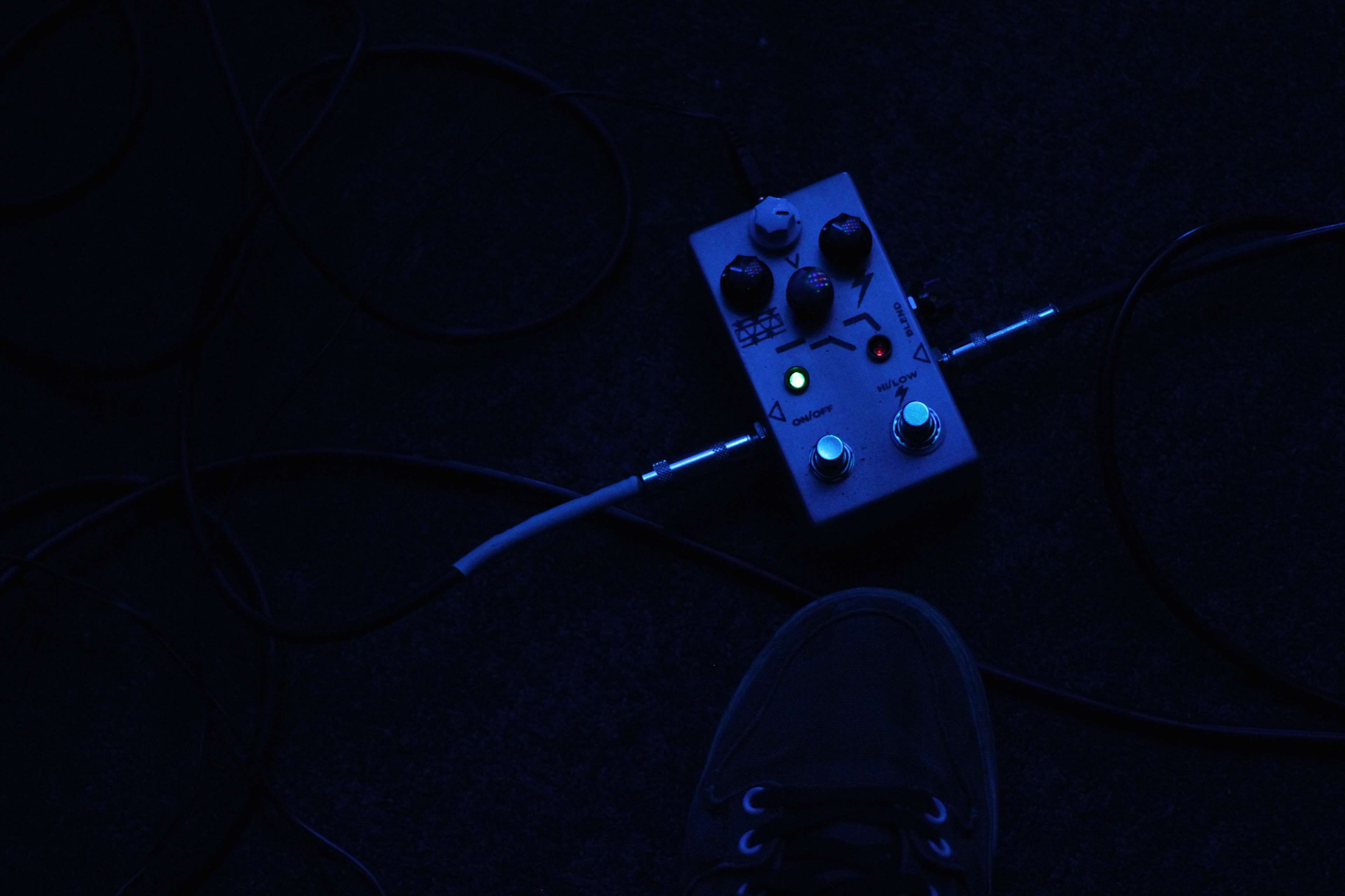 3840x2560 Wallpaper / holding, pedals, studio shot, black background, technology, indie, bass, blue, distortion, music, 4K, directly above, guitar, indoors, wireless technology free download