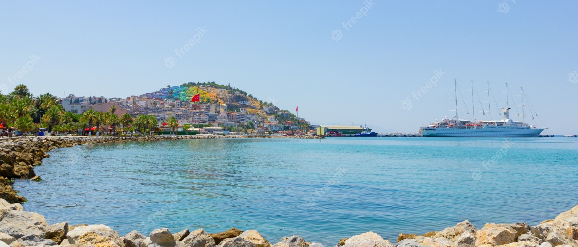 2000x857 Premium Photo. Cruise ship is located on the port of kusadasi, turkey. panoramic view in kusadasi town of turkey