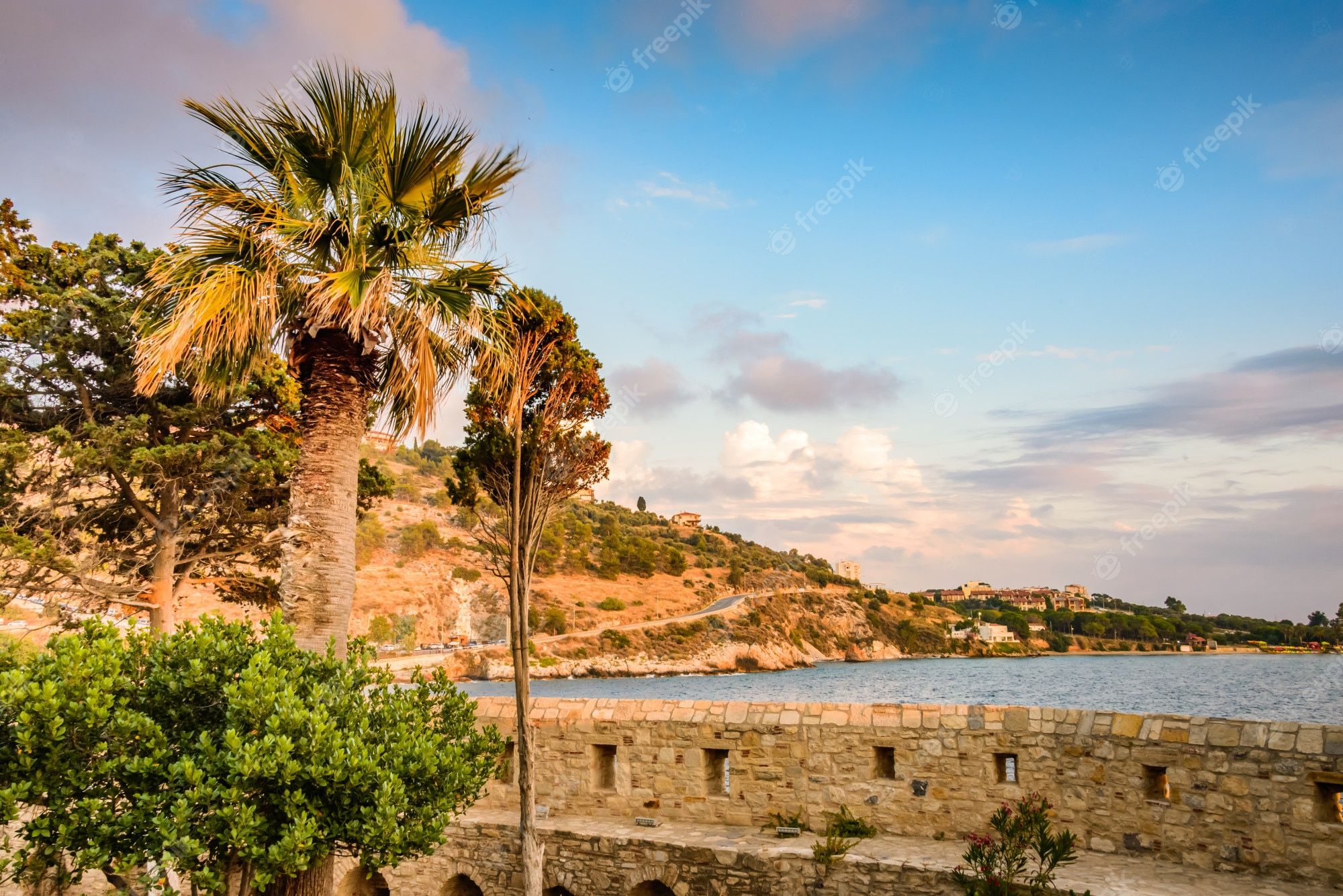 2000x1335 Premium Photo. Beautiful sunset on the stone walls of bird island in kusadasi, turkey