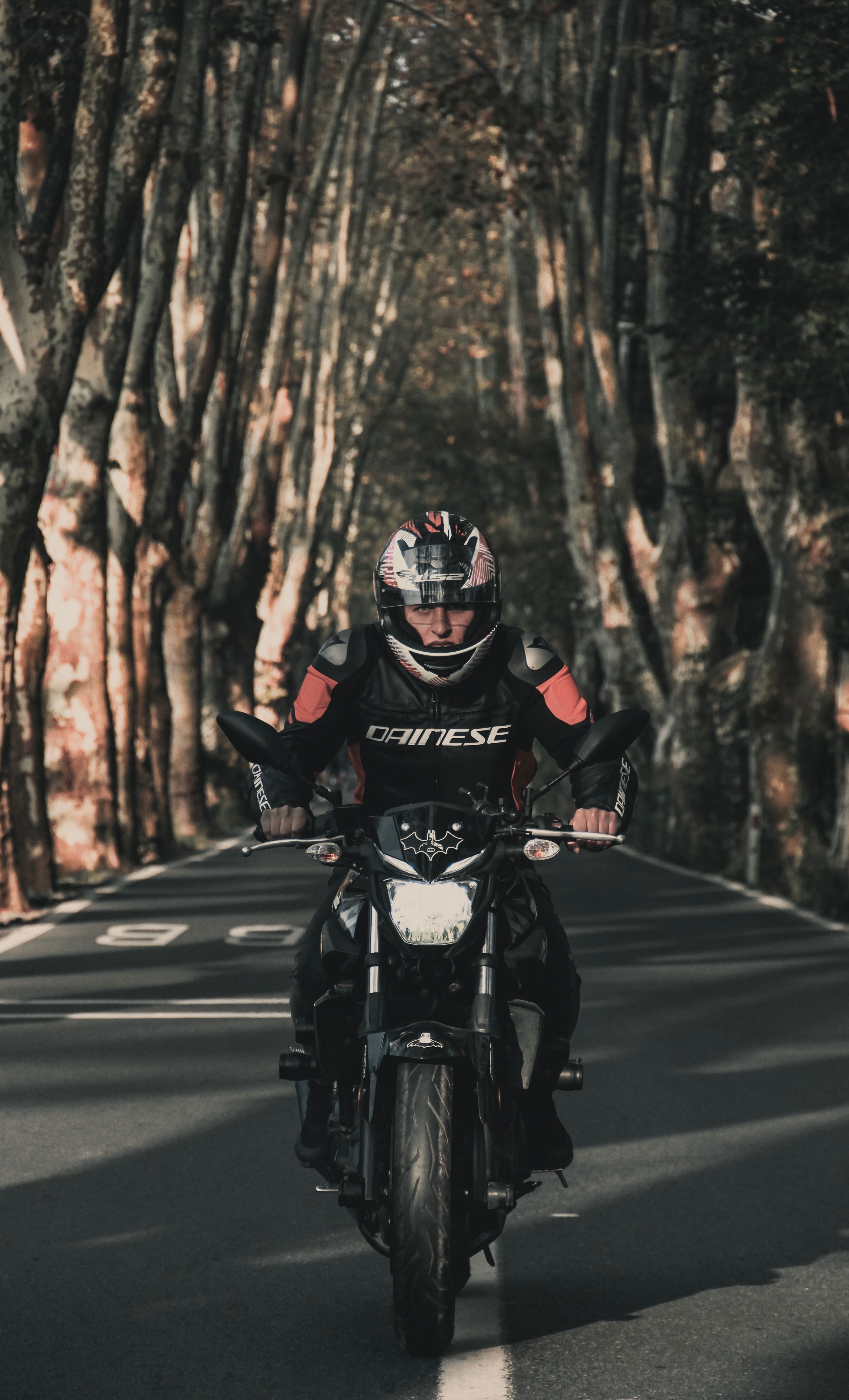 3143x5180 Wallpaper Man in Black and Red Motorcycle Suit Riding Motorcycle on Road During Daytime, Background Free Image