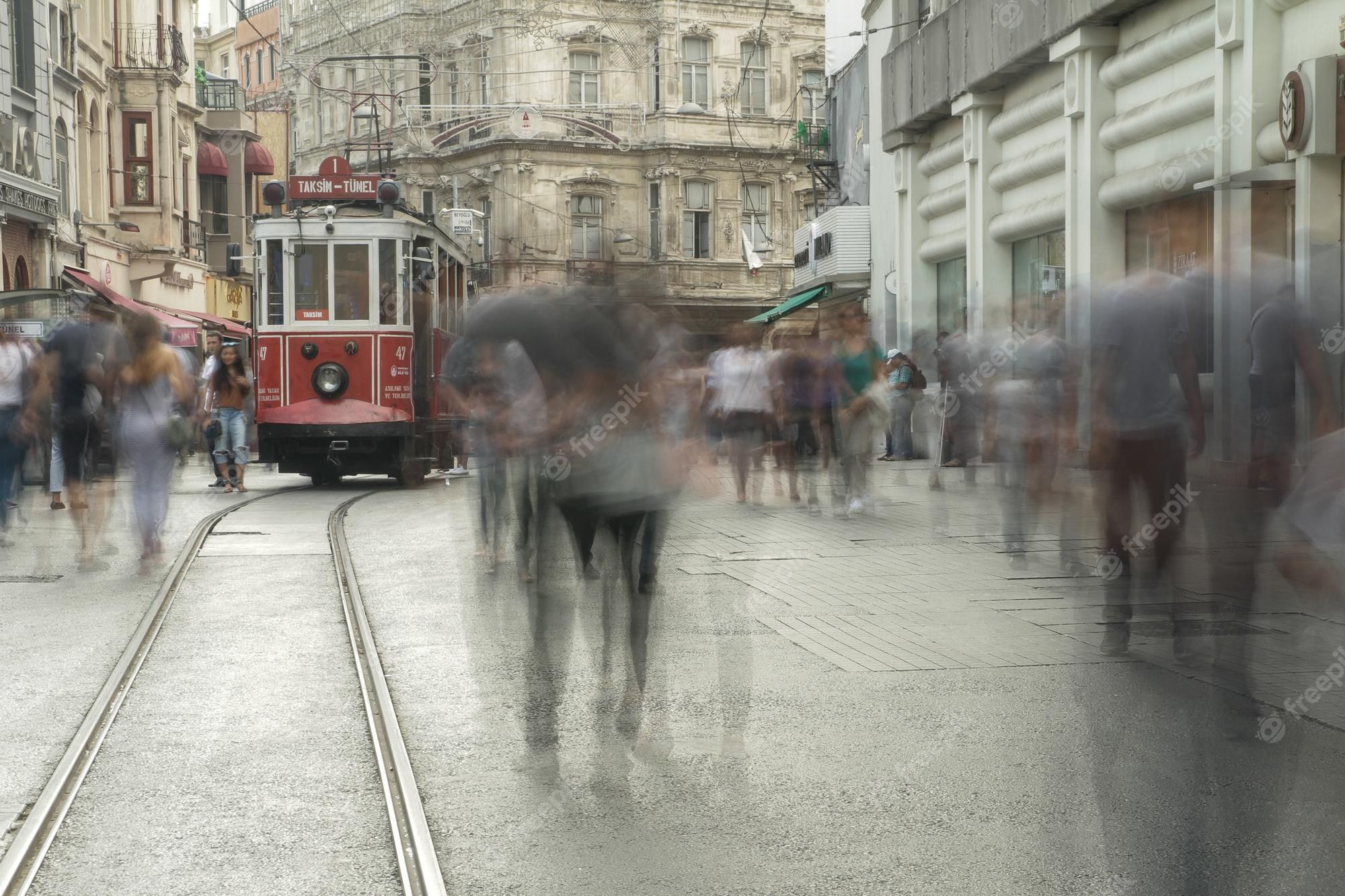 2000x1333 Premium Photo. Tram passing through taksim square people in silhouette