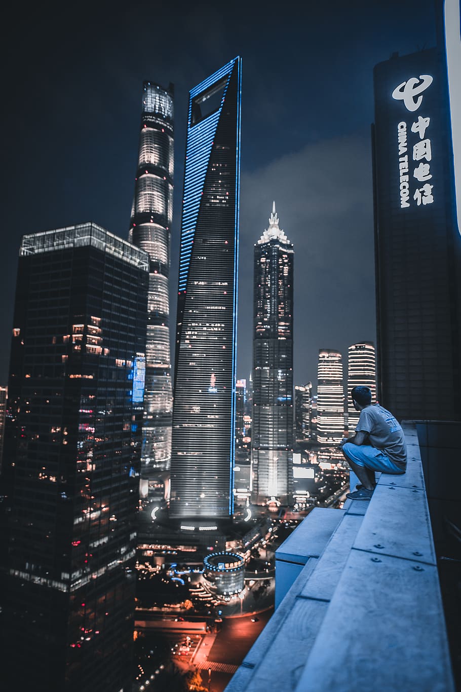 910x1365 HD wallpaper: man sitting on roof top viewing city view, building, high rise
