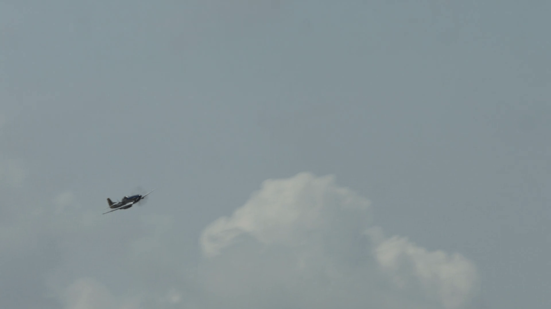 1920x1080 North American P 51 Mustang Fighter Plane Passes From Left, Then