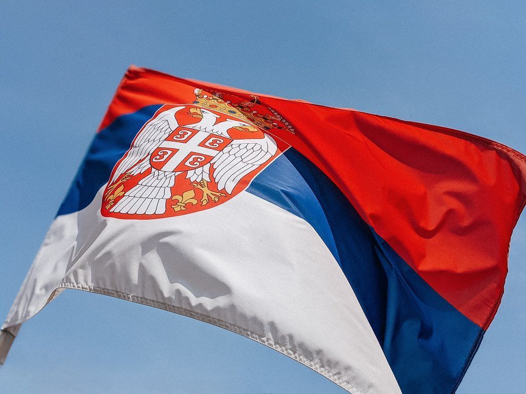 1024x768 Close Up Of The Serbian Flag With Blue Sky In The Backgrou