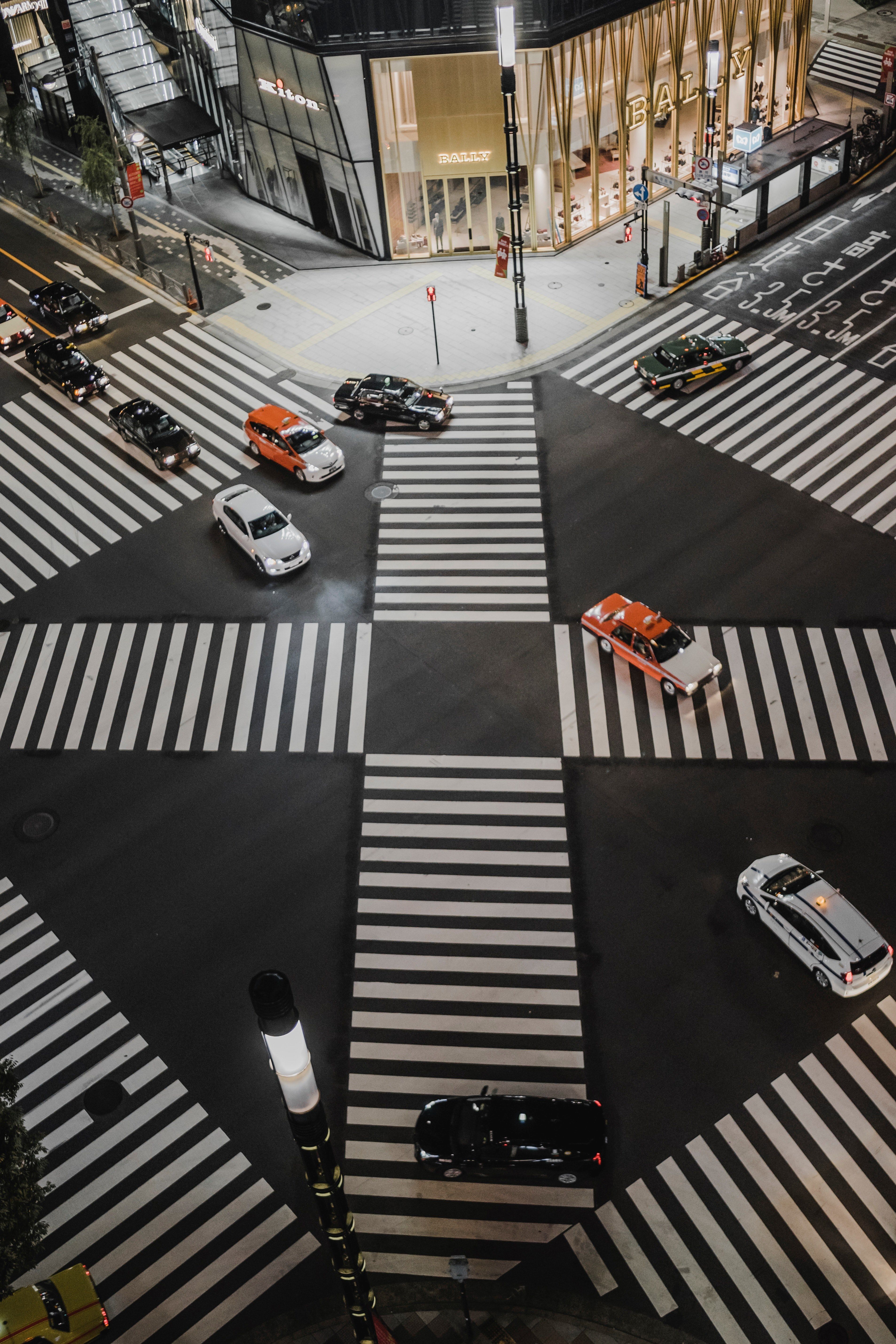 3813x5719 Wallpaper / illuminated traffic intersection in ginza with crosswalks going in many directions and cars driving past, japan pt_ 2 4k wallpaper free download