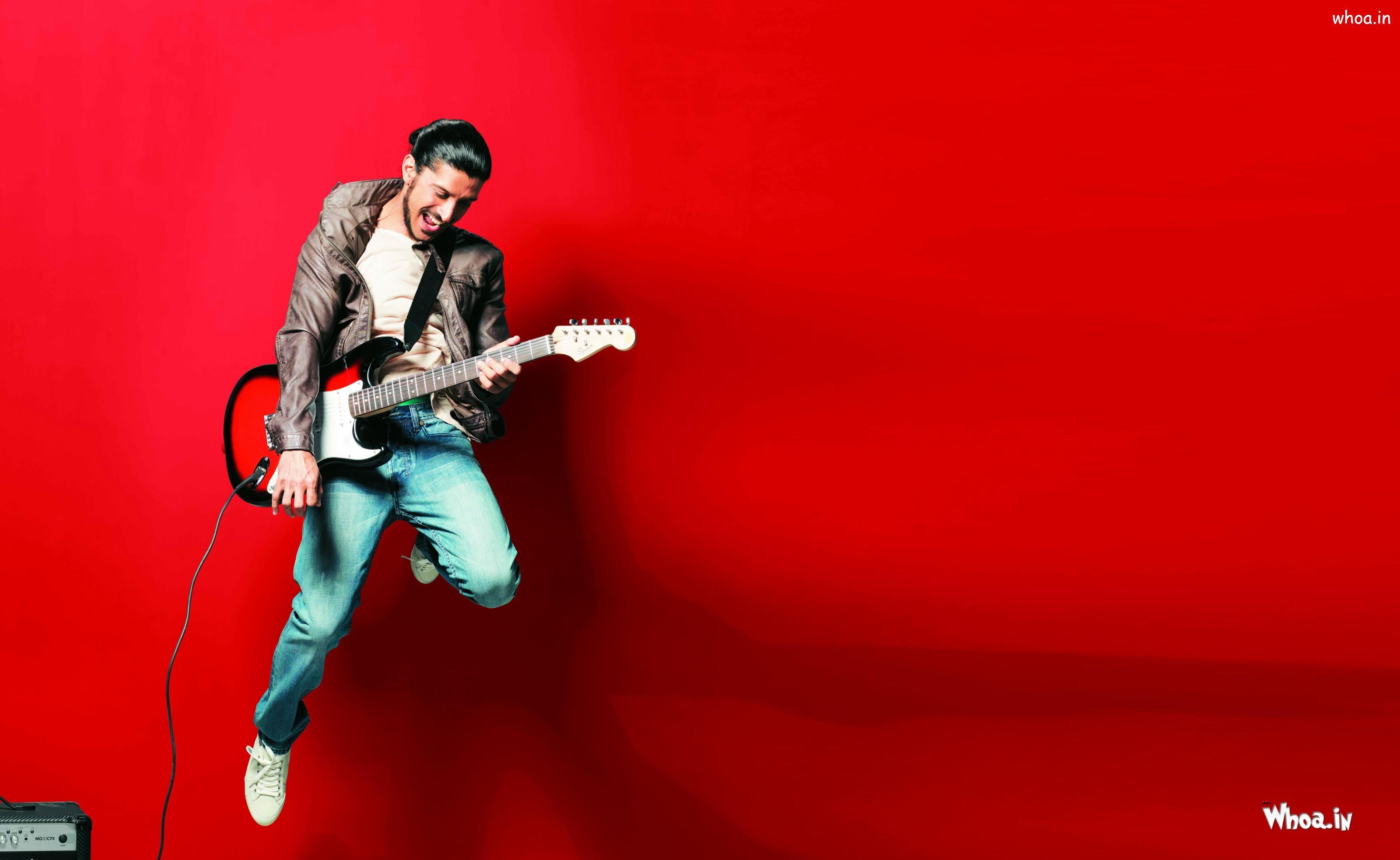 3200x1966 Farhan Akhtar Playing Guitar With Red Background HD Wallpaper