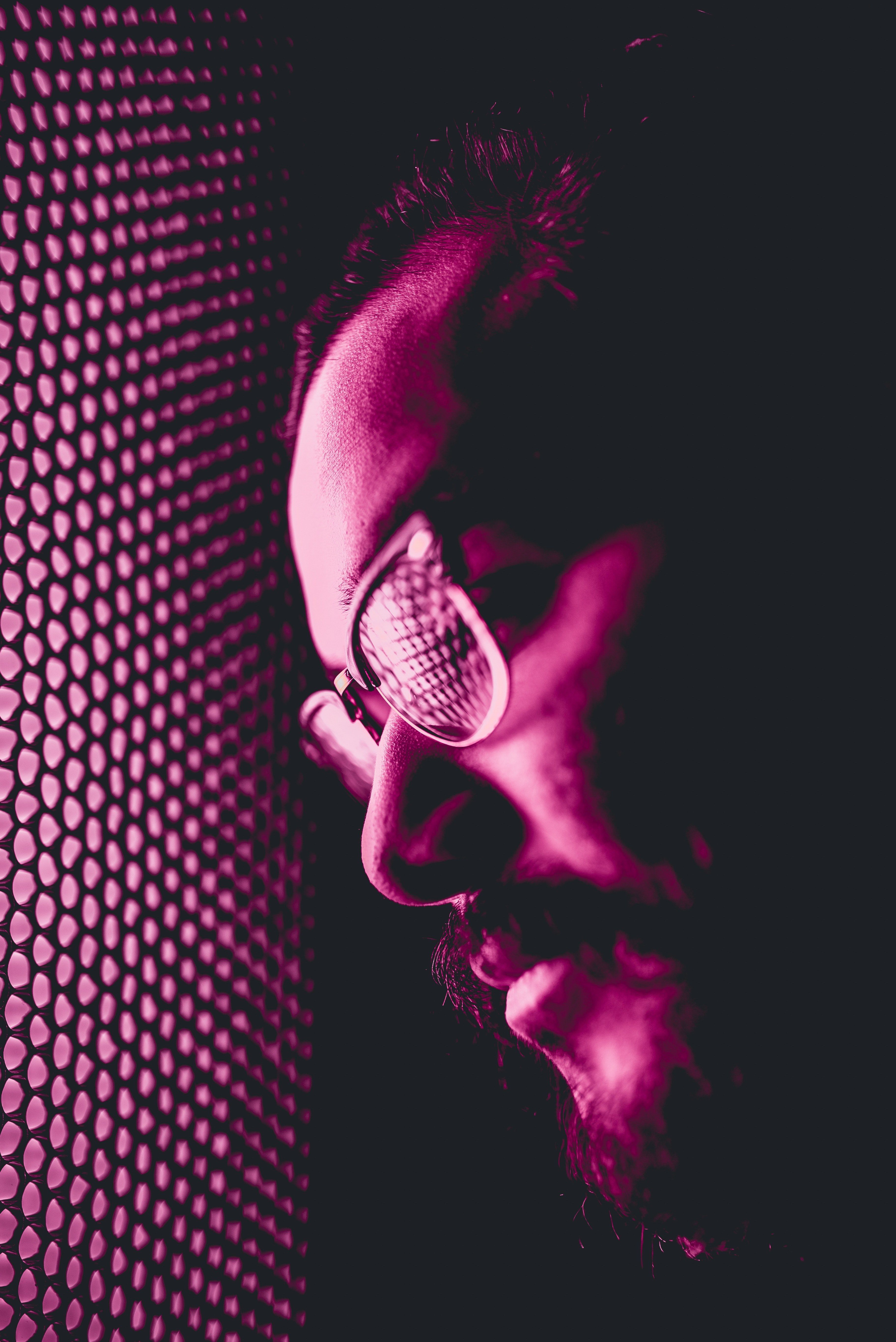 3648x5464 Wallpaper / a man leaning against mesh covering a pink light in vistek, glow up 4k wallpaper free download