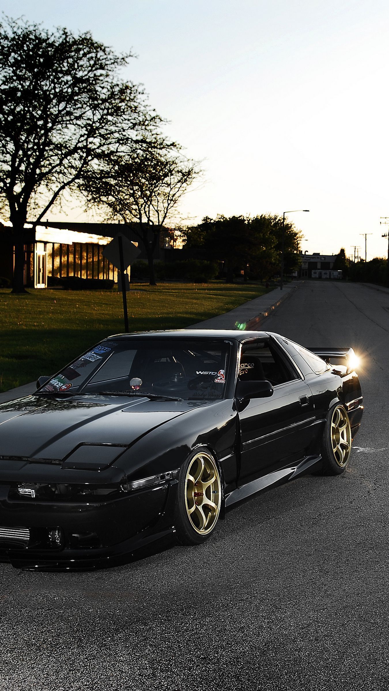 1350x2400 Download wallpaper 1350x2400 toyota, supra, ma black, front part, tuning, street, sun, glare iphone 8+/7+/6s+/for parallax HD background