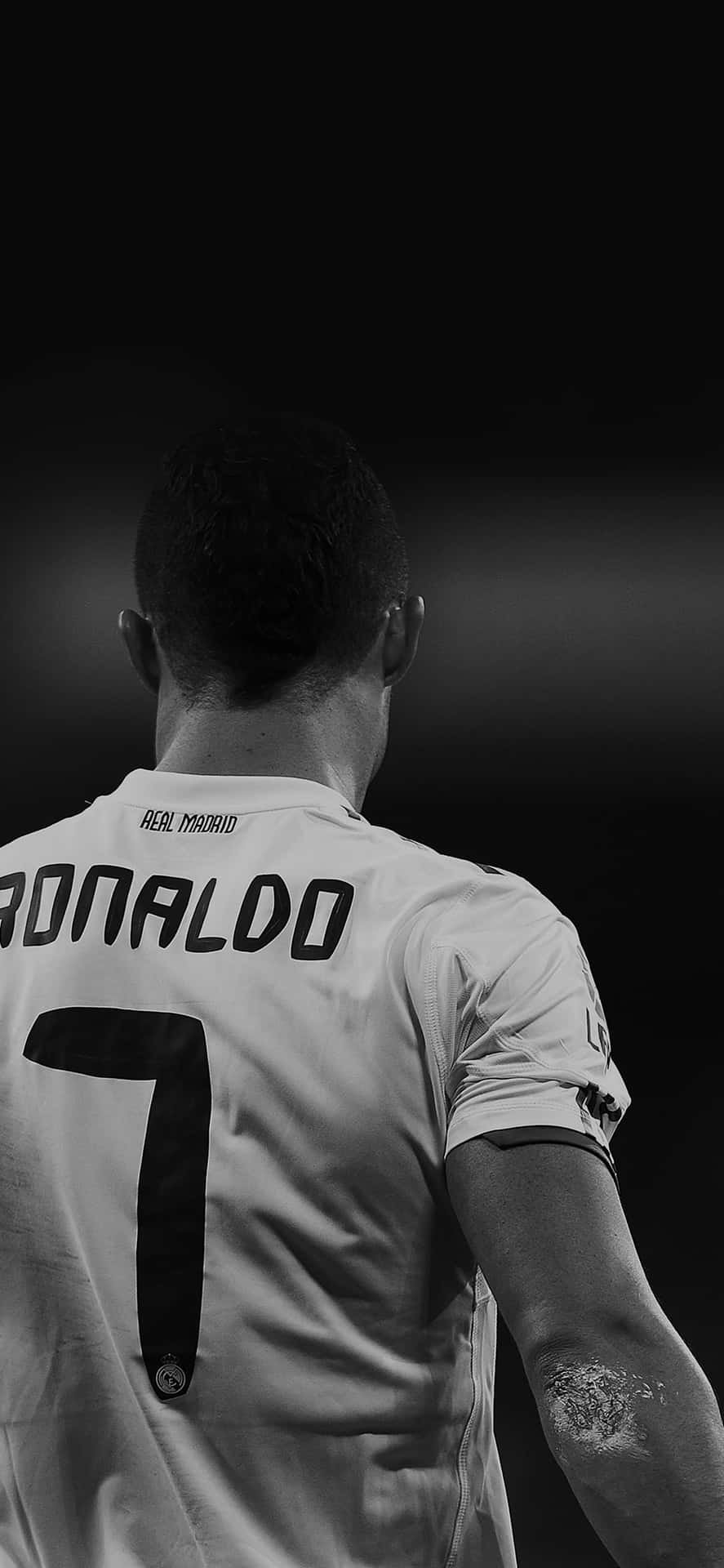 887x1920 Download Cristiano Ronaldo taking a free kick during a soccer match Wallpaper